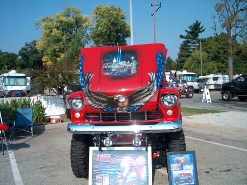 1978 Ford Bronco - Customized 1955 truck with patriotic mural, parked outdoors with other vehicles visible.