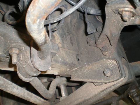 1966 Ford Mustang - Close-up view of the front suspension system, showing various mechanical parts and linkages.