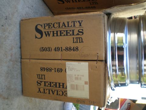 1966 Ford Mustang - Cardboard boxes from Specialty Wheels Ltd. are stacked next to a set of chrome wheels.