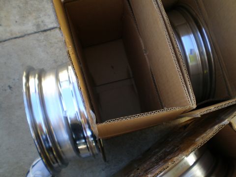 1966 Ford Mustang - New chrome wheels are packed in cardboard boxes, ready for installation.