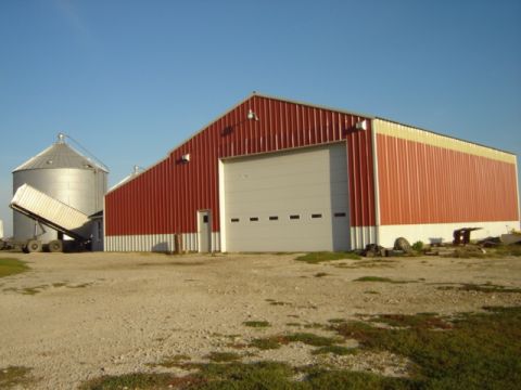 1992 Ford Bronco - A red barn with a large white garage door and a metal silo stands under a clear blue sky.