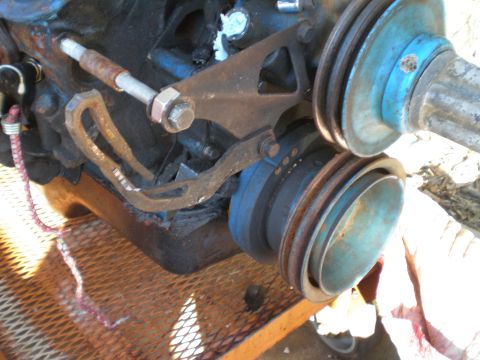 1966 Ford Mustang - Close-up of an engine's pulley bracket and associated hardware.