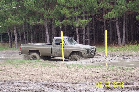 1978 Ford Bronco - This pickup truck is navigating through a muddy off-road course.