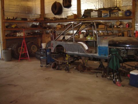 1992 Ford Bronco - Workshop scene with a disassembled Jeep CJ-7 body and frame undergoing repairs.