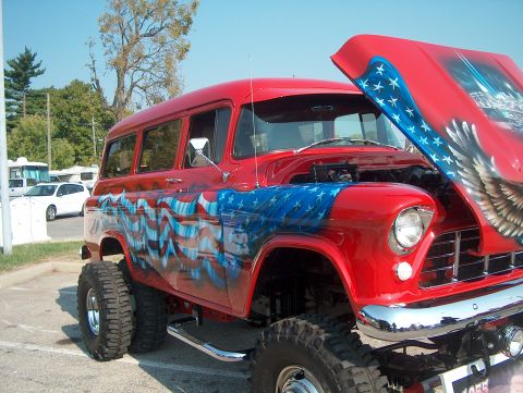 1978 Ford Bronco - This lifted SUV features patriotic airbrush art on its hood and sides, with a visible 1955 grille.