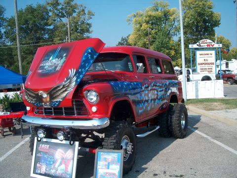 1978 Ford Bronco - Custom 1955 Chevrolet Suburban with patriotic theme and lifted suspension displayed at an event.