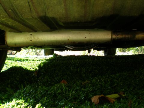 1966 Ford Mustang - The underside of a vehicle is visible, with focus on the exhaust pipe and muffler system.