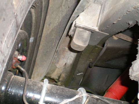 1966 Ford Mustang - Close-up view of the undercarriage, revealing the rear axle and brake system components.