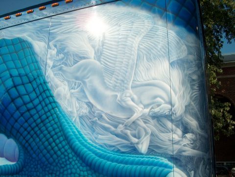 1978 Ford Bronco - A detailed airbrushed mural depicts a mythical scene with Pegasus and a dragon on the side of a vehicle.