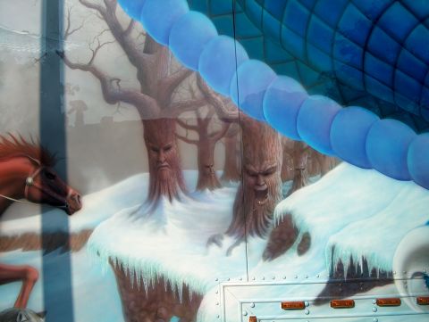 1978 Ford Bronco - A mural depicts a winter scene with anthropomorphic trees and a horse, set against a backdrop of blue, segmented elements.