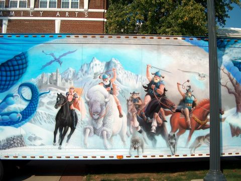 1978 Ford Bronco - A mural on a trailer displays a fantasy scene with dragons, warriors, and wolves.
