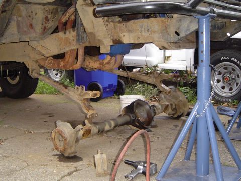 1978 Ford Bronco - The front axle and suspension components of a vehicle are disassembled and supported by stands.