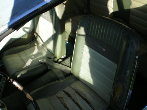 1966 Ford Mustang - Interior view of a 1966 Ford Mustang, highlighting the worn condition of the front seats.