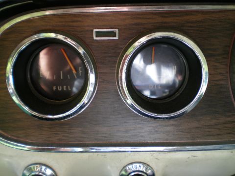 1966 Ford Mustang - Close-up of the 1966 Ford Mustang's interior dashboard, showing the fuel and oil gauges.