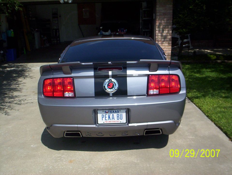 Rear of gray Mustang with black stripes and Texas PEKA BU plate