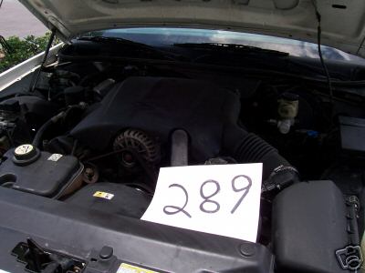 2001 Ford Crown Victoria - The engine bay of a vehicle is shown, with a piece of paper displaying the number 289 placed on top.