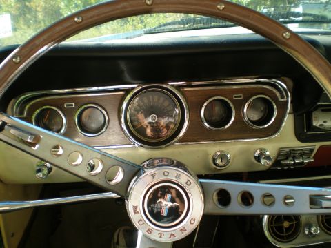 1966 Ford Mustang - The dashboard of a 1966 Ford Mustang features a wood-grain trim and classic instrumentation.