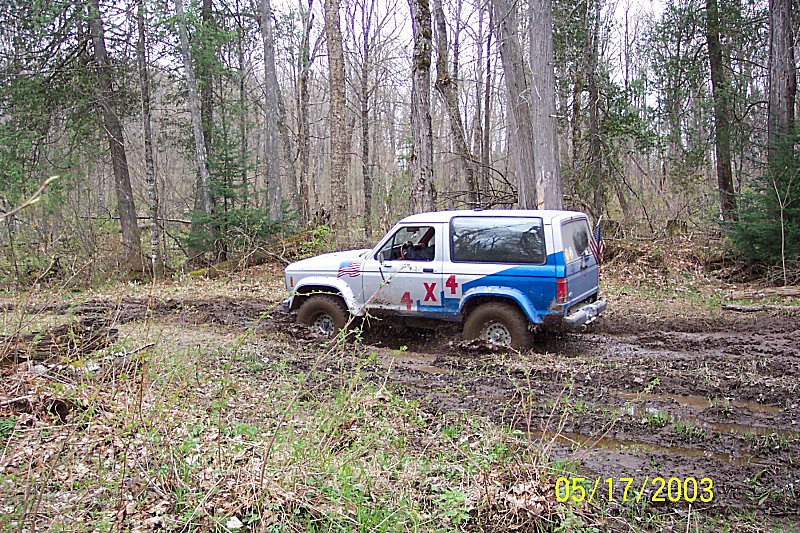 Ford Bronco II stuck in mud with 4x4 decals on the side