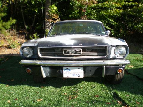 1966 Ford Mustang - Front view of a 1966 Ford Mustang, with a license plate clearly displaying the year.