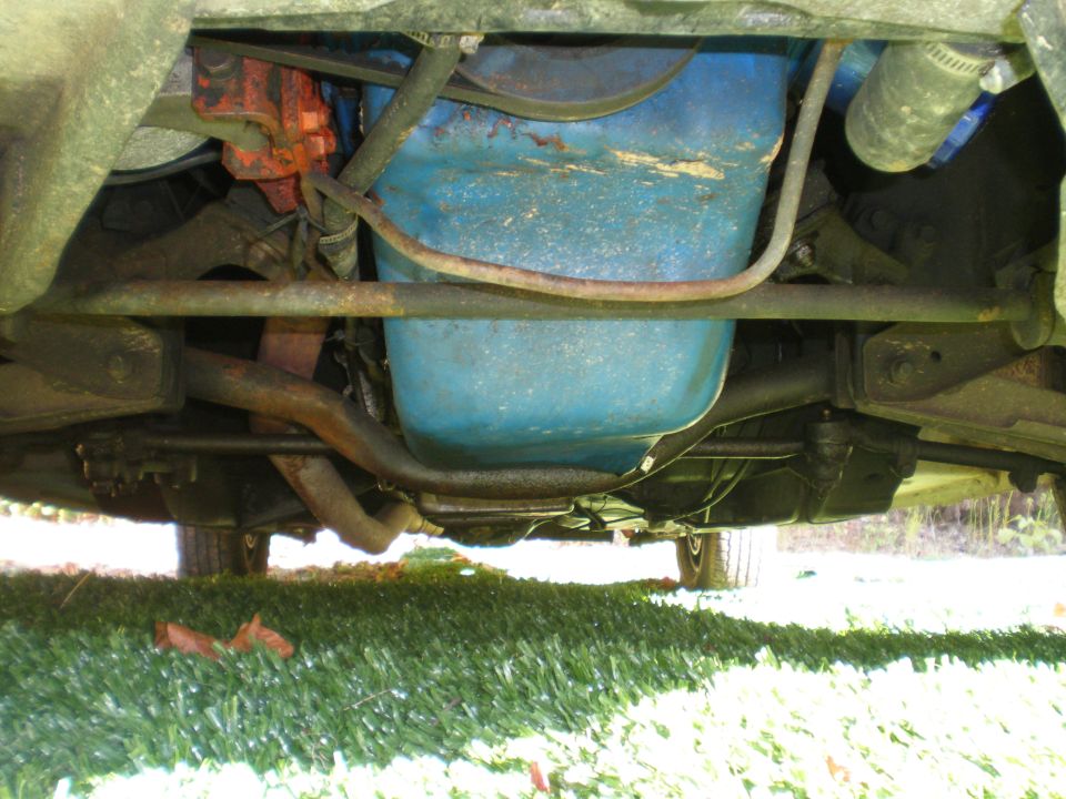 Underside view of a 1966 Ford Mustang engine with a blue oil pan