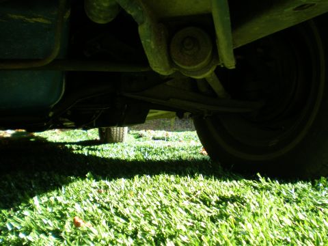 1966 Ford Mustang - Close-up of a vehicle's undercarriage, focusing on suspension and wheel assembly.