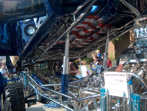 1978 Ford Bronco - Custom show truck chassis with chrome tubing and a large V8 engine on display.