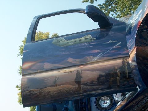 1978 Ford Bronco - A truck door displays an airbrushed military scene with aircraft and soldiers.