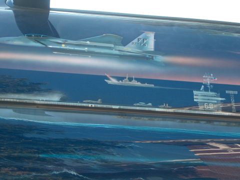 1978 Ford Bronco - A detailed mural depicts a naval scene with fighter jets, an aircraft carrier, and other warships sailing on the ocean.