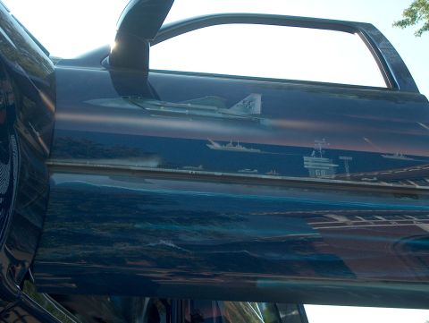 1978 Ford Bronco - Airbrushed artwork on a vehicle door depicts a naval fleet with an aircraft carrier and fighter jet.