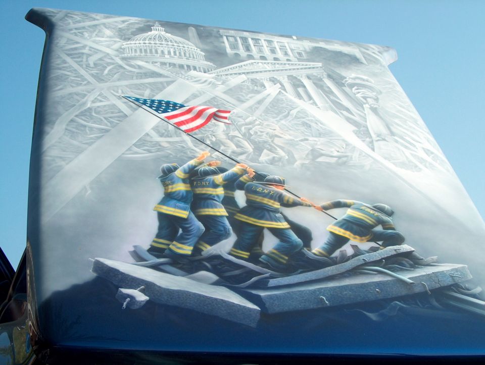 Airbrushed FDNY flag-raising 9/11 memorial mural covering a vehicle hood
