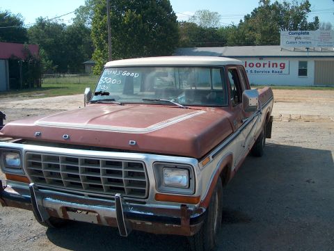 1979 Ford F-250 - This 1979 Ford F-250 truck is seen from the front 3/4 angle, with visible text on the windshield.