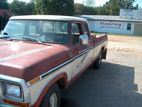 1979 Ford F-250 - This 1979 Ford F-250 Super Cab truck is seen from the front three-quarter angle, parked on a gravel lot.