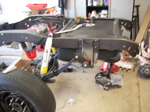1992 Ford Bronco - Close-up of a vehicle's frame and suspension system during a build or repair.