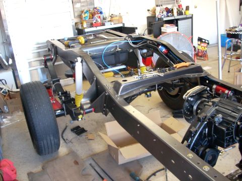 1992 Ford Bronco - The frame and suspension components of a vehicle are visible in this three-quarter front view, suggesting a restoration or custom build pro…