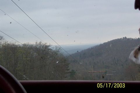 1978 Ford Bronco - View from inside a vehicle looking out at a wooded hillside and sky. Date stamp 05/17/2003.