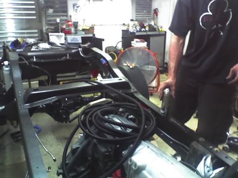 1992 Ford Bronco - The chassis of a vehicle is shown with its engine and transmission components during a repair or build process.