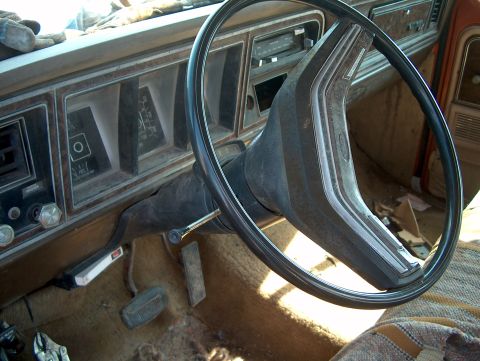 1979 Ford F-250 - The interior of a 1979 Ford F-250 features a worn dashboard and steering wheel.