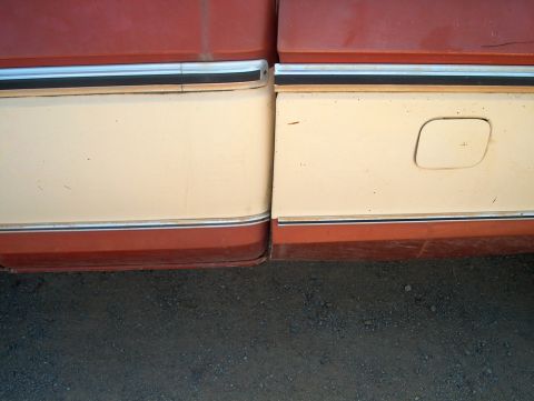 1979 Ford F-250 - Close-up of the side of a 1979 Ford F-250 showing its two-tone paint scheme and trim details.