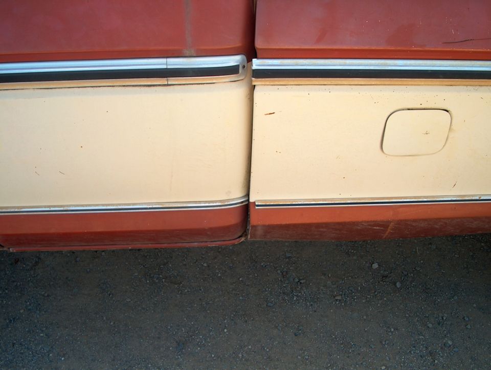 Two-tone red and tan truck body panels with chrome trim and a fuel door