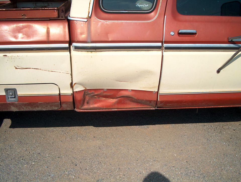 1979 Ford F-250 Super Cab side view showing significant damage to the lower rear quarter panel and door