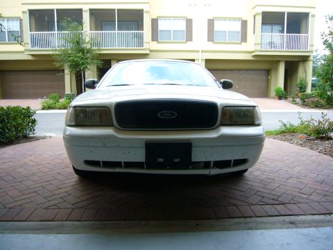 2001 Ford Crown Victoria - Front view of a white 2001 Ford Crown Victoria parked on a brick driveway.