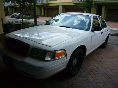 2001 Ford Crown Victoria - A white 2001 Ford Crown Victoria is parked on a brick driveway.
