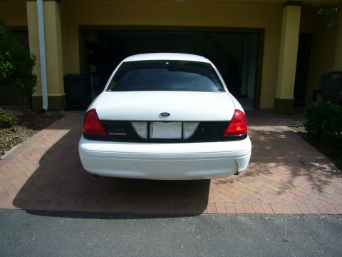 2001 Ford Crown Victoria - Rear view of a white 2001 Ford Crown Victoria parked in a driveway.