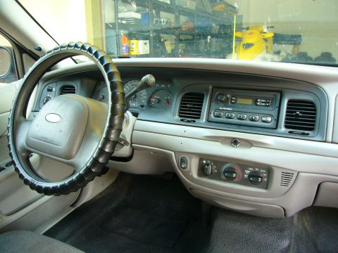 2001 Ford Crown Victoria - Interior view of a 2001 Ford Crown Victoria, highlighting the dashboard, steering wheel, and center console.