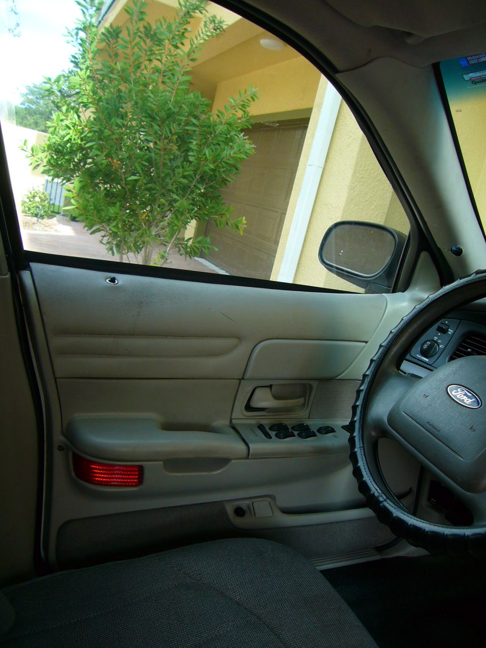 Interior view of a 2001 Ford Crown Victoria showing door panel and steering wheel