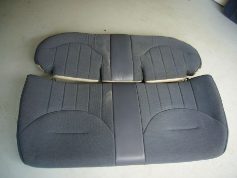 2001 Ford Crown Victoria - A pair of gray car seats, likely from the rear of a vehicle, are displayed on a light-colored floor.