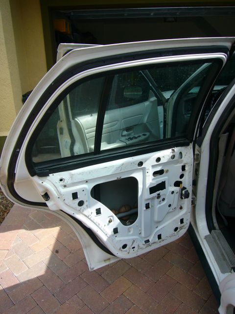 2001 Ford Crown Victoria - Rear door interior of a 2001 Ford Crown Victoria with the door panel removed for access.