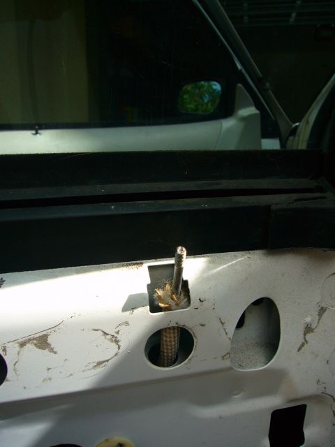 2001 Ford Crown Victoria - The interior of a car door reveals the mechanical components behind the panel.
