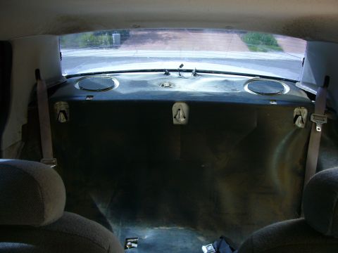 2001 Ford Crown Victoria - The interior of a car's rear seating area and trunk access, viewed from the front seats.