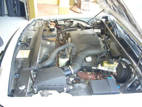 2001 Ford Crown Victoria - The engine compartment of a car is open, revealing various mechanical components and fluids.